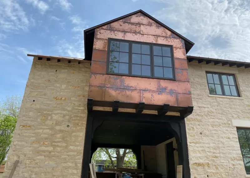 Copper metal panel facade on a stone building for Metal Roof Coating in Rockwall